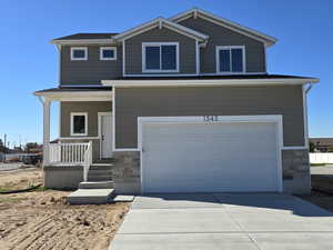 View of front of home featuring covered porch and a garage