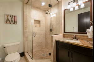 Bathroom with vanity, toilet, and walk in shower