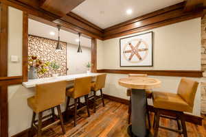 Dining room with dark hardwood / wood-style flooring