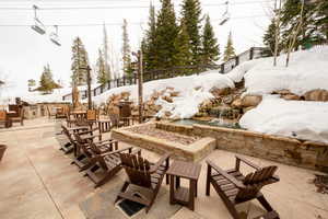 Snow covered patio with a fire pit