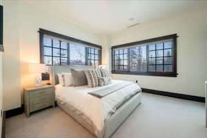 Bedroom featuring light colored carpet