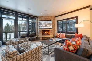 Living room featuring a fireplace, hardwood / wood-style flooring, and ornamental molding