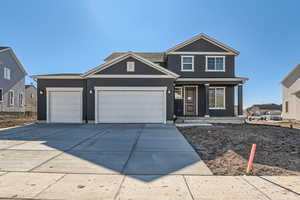 View of front of property with a garage and a porch