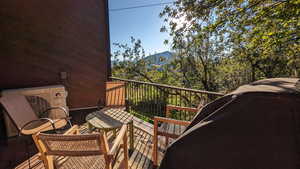 Wooden deck with a mountain view and ac unit