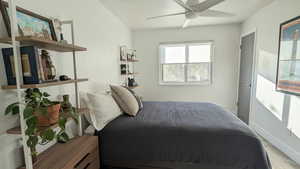 Bedroom with ceiling fan and light wood-type flooring