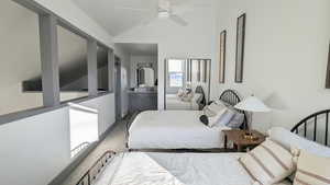 Bedroom with carpet flooring, ceiling fan, and lofted ceiling