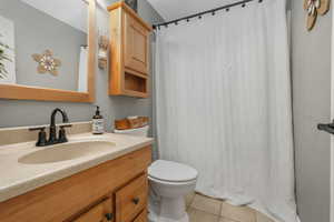 Bathroom with tile patterned flooring, vanity, and toilet