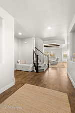 Corridor featuring dark hardwood / wood-style floors and a textured ceiling