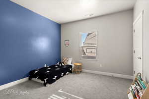 Bedroom with carpet flooring and a textured ceiling