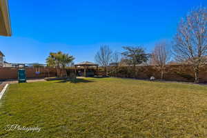 View of yard featuring a gazebo and a playground