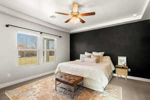 Carpeted bedroom featuring a textured ceiling and ceiling fan