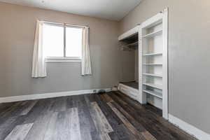 Mudroom featuring dark hardwood / wood-style flooring, a textured ceiling, and built in features