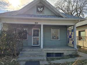 Exterior entry at dusk featuring covered porch