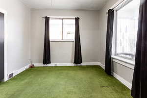 Spare room featuring carpet floors and a textured ceiling