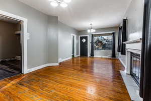 Entryway with wood-type flooring and an inviting chandelier