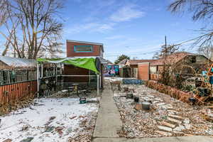 Yard covered in snow featuring a storage shed