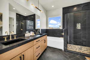 Bathroom featuring decorative backsplash, vanity, and independent shower and bath