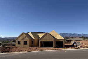 Property in mid-construction featuring a mountain view and a garage
