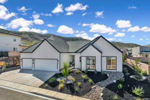 View of front of home with a garage and a mountain view