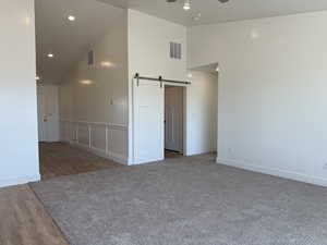 Spare room with recessed lighting, visible vents, a barn door, and ceiling fan