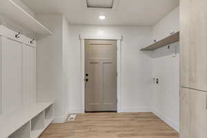 Mudroom with light hardwood / wood-style floors