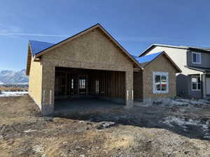 Property in mid-construction featuring a garage and a mountain view