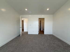 Unfurnished bedroom featuring visible vents, recessed lighting, baseboards, and dark colored carpet