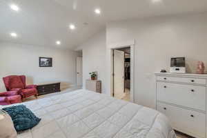 Bedroom featuring lofted ceiling