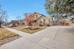 View of front of property with a front lawn and a garage