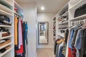 Walk in closet featuring light carpet