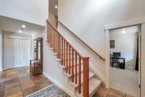 Stairway featuring carpet flooring and ornamental molding