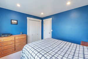 Carpeted bedroom with a closet