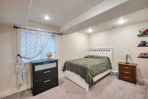 Bedroom featuring light colored carpet