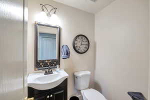 Bathroom featuring vanity and toilet