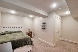 Carpeted bedroom featuring a closet