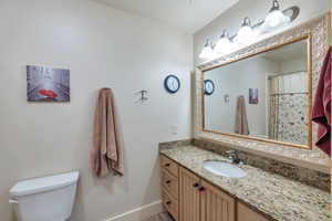 Bathroom featuring vanity and toilet