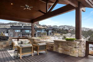 Snow covered deck featuring ceiling fan, a mountain view, and an outdoor hangout area