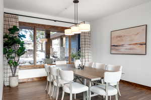 Dining space with dark wood-type flooring