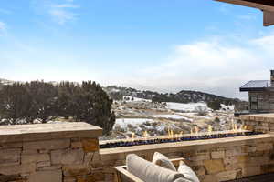 Snow covered patio featuring a mountain view