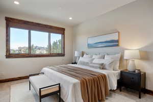 Bedroom featuring light colored carpet