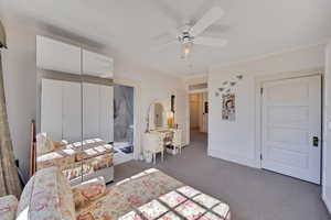 Large dressing room attached to master bedroom and bathroom with built-in clothing and shoe storage.