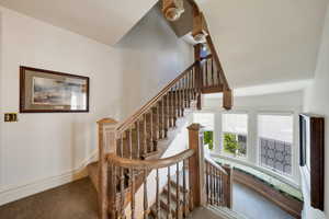 Stairway featuring beautiful original railing and banister.