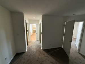 Corridor with dark colored carpet