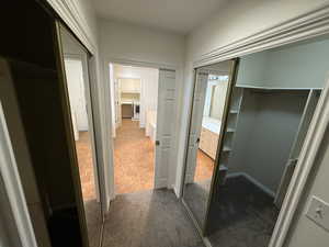 Corridor featuring carpet flooring