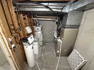 Utility room with heating unit and strapped water heater