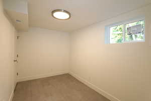 Spare room featuring wood-type flooring