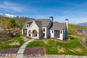 View of front of house with a mountain view and a front yard