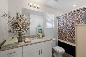 Bathroom featuring vanity and toilet