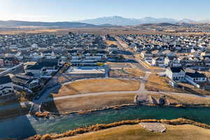 Birds eye view of property featuring a water and mountain view