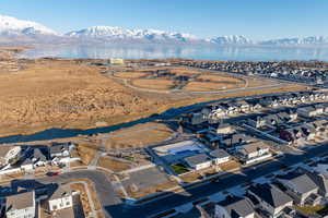 Birds eye view of property featuring a water and mountain view